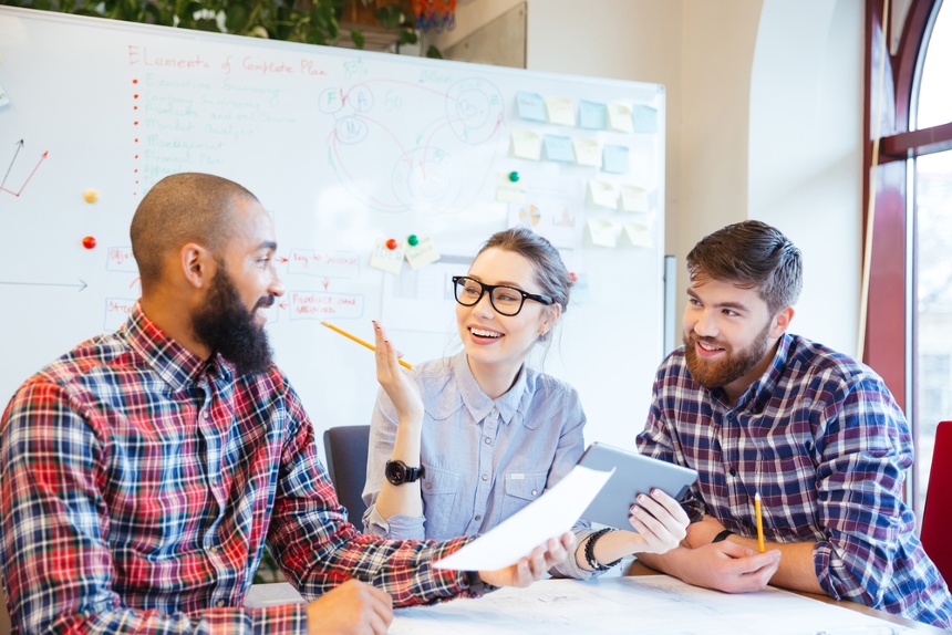 Happy group of co-workers having a discussion