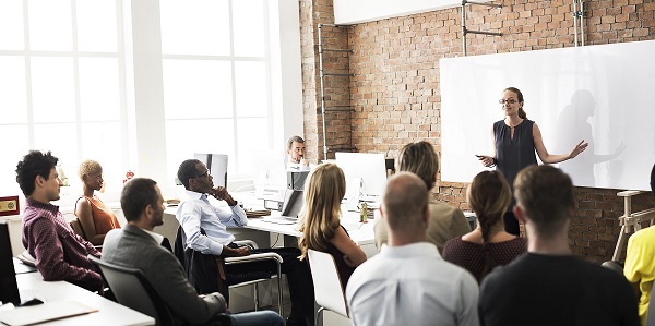 Teacher delivering training to a room full of people
