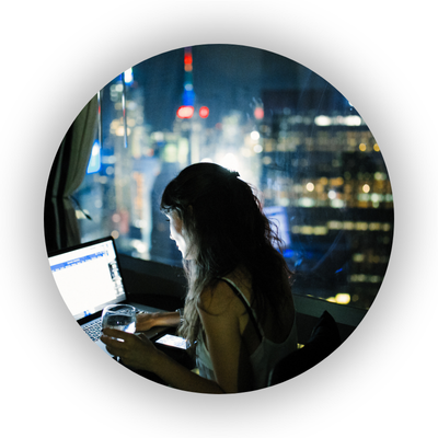 Woman working at laptop late at night