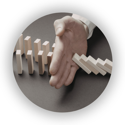 Person stopping dominoes from falling