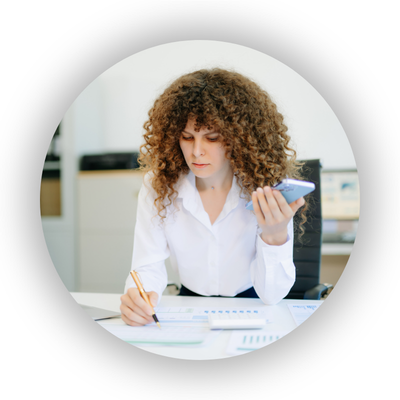 Professional woman working on paper and using phone